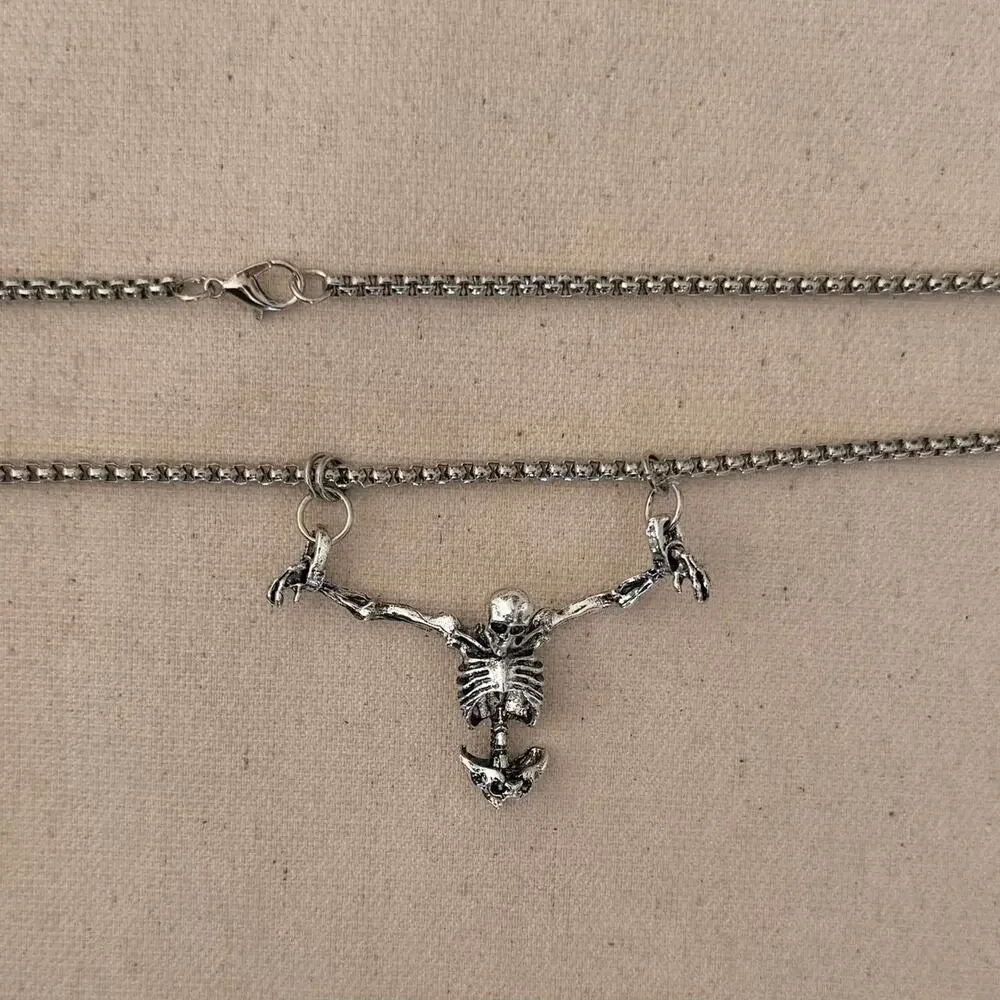 Silver skeleton necklace on a